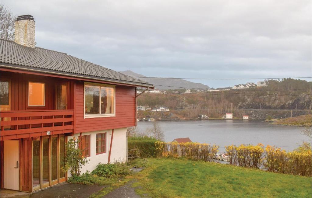 a red house with a view of a lake at Lovely Home In Finns With House A Panoramic View in Kuleseid