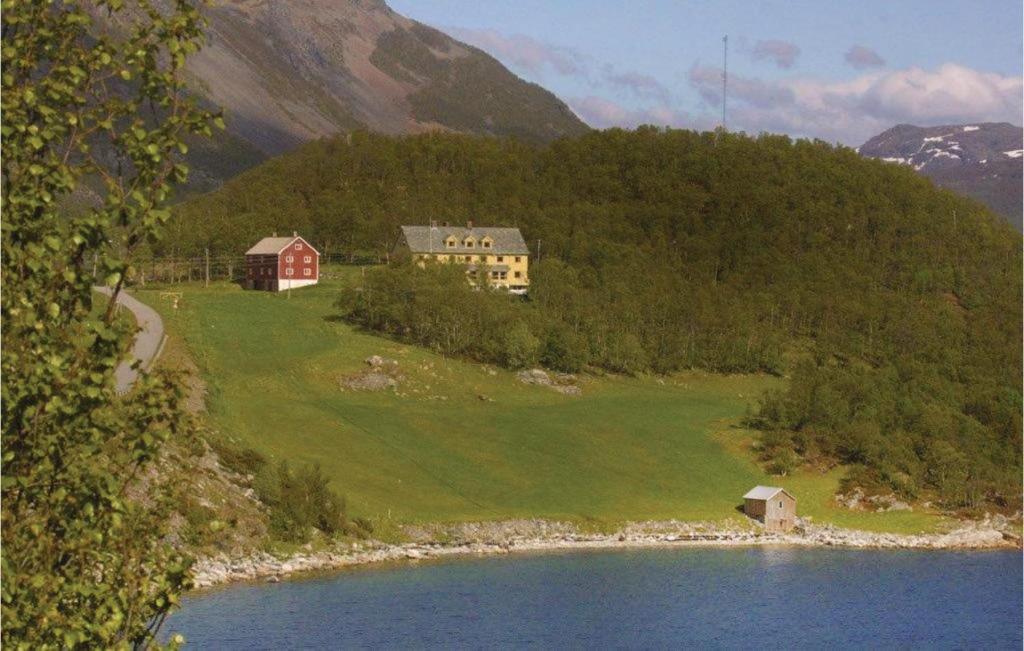 a house on a hill next to a body of water at Nice Home In Korsfjorden With 4 Bedrooms And Wifi in Komagfjord