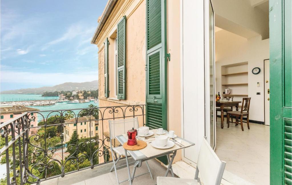 a balcony with a table and chairs and a view of the ocean at Tulipano in San Michele di Pagana
