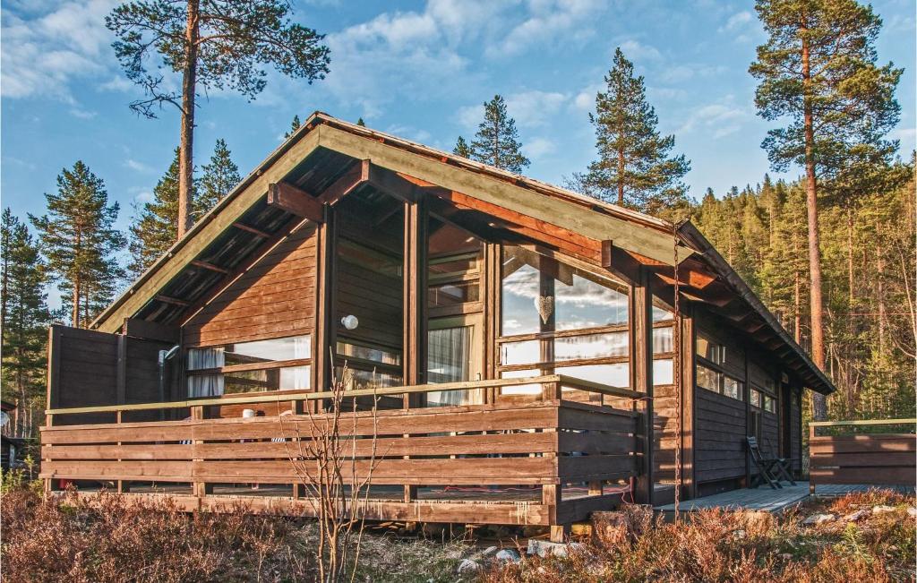 a wooden cabin in the woods with trees at Cozy Home In Rendalen With House A Mountain View in Svarstad