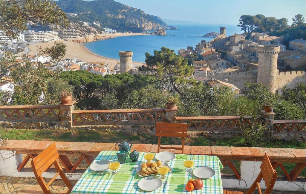 a table with food on it with a view of the ocean at 2 Bedroom Nice Home In Tossa De Mar in Tossa de Mar