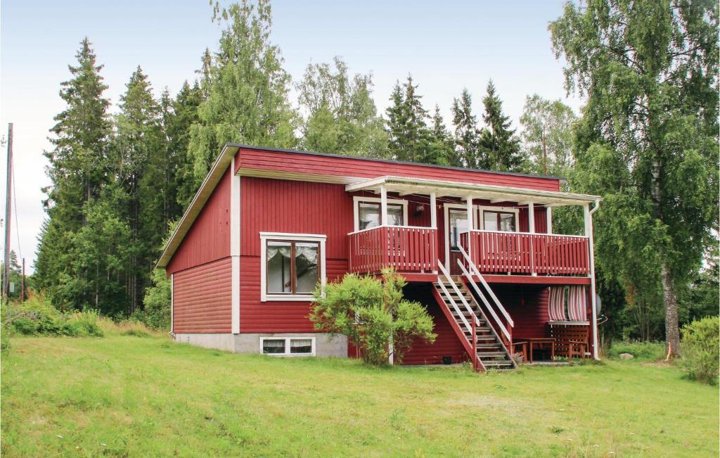 a red house with a red deck and a porch at 2 Bedroom Lovely Home In Rottne in Rottne