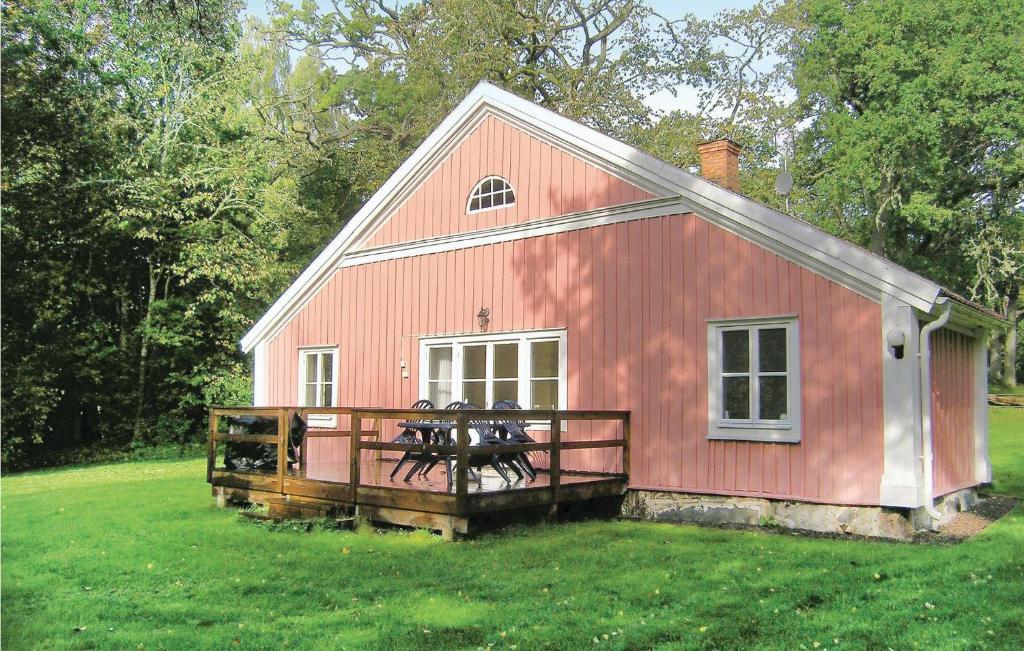 a red barn with two horses on a porch at Holiday Home Braås Herrgård Braås in Braås