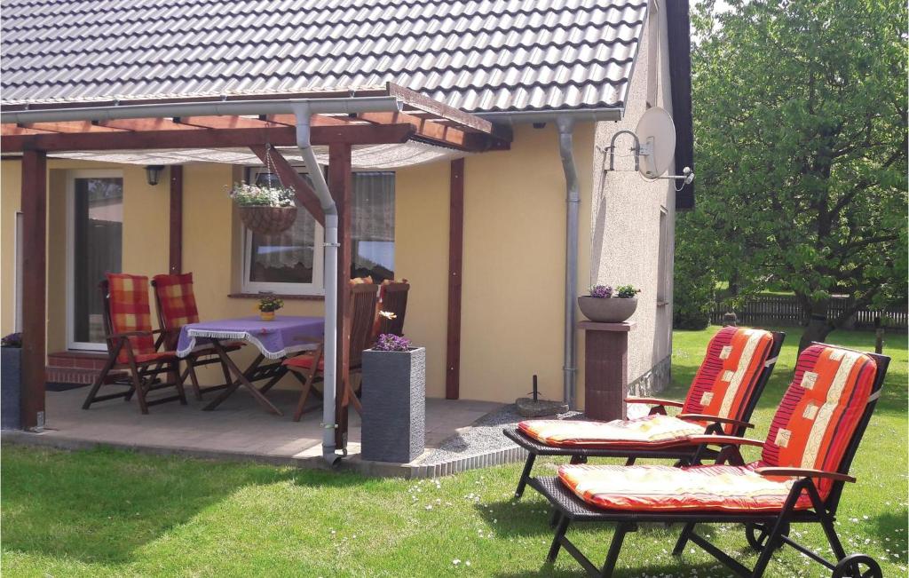 a patio with chairs and a table in the grass at Awesome Home In Alt Schwerin With Wifi in Alt Schwerin