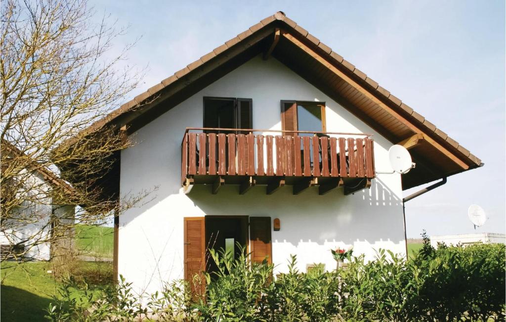 a white house with a balcony on it at Ferienhaus 26 In Kirchheim in Kirchheim