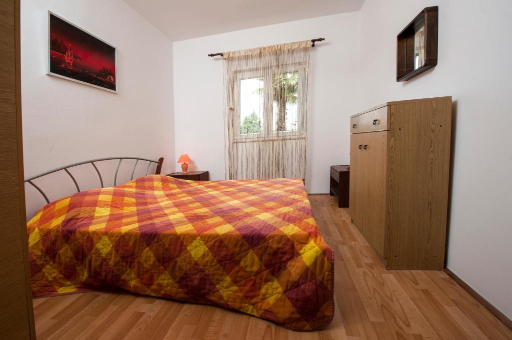 Łóżko lub łóżka w pokoju w obiekcie Apartments Vidaković