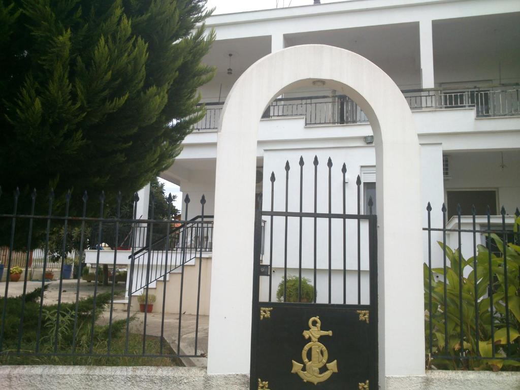 an entrance to a building with a gate with a sign on it at Kalaitzis Apartments in Kalivia Poligirou