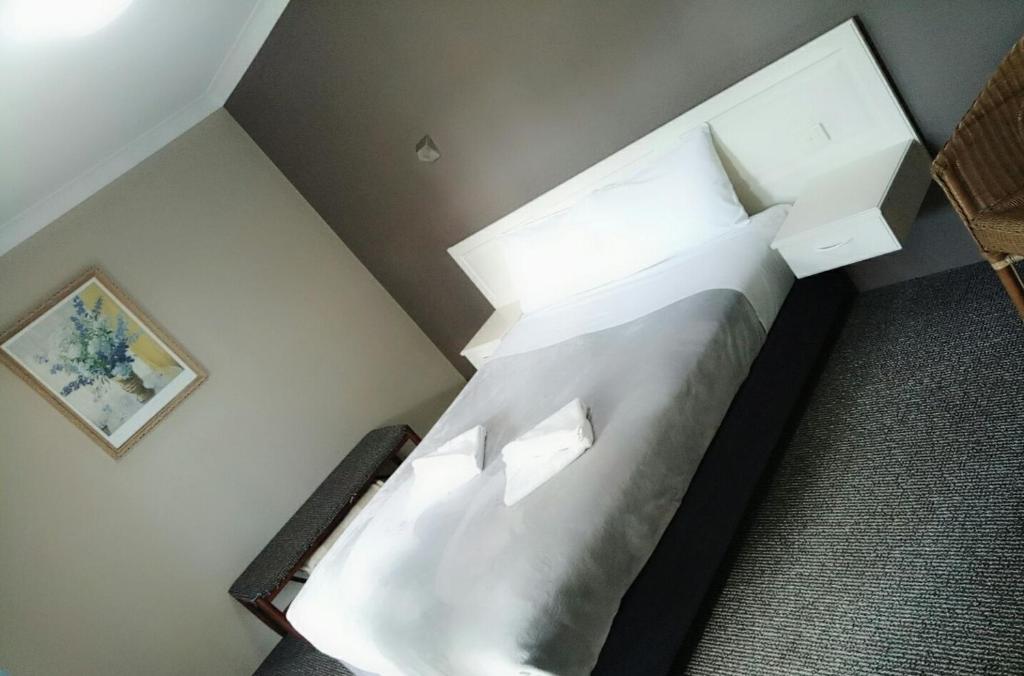 Postel nebo postele na pokoji v ubytování Excelsior Motor Inn