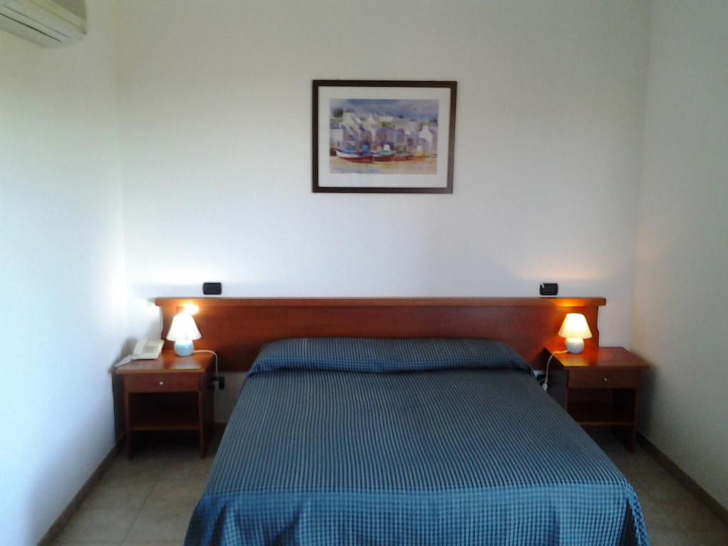 Postel nebo postele na pokoji v ubytování Hotel Il Melograno