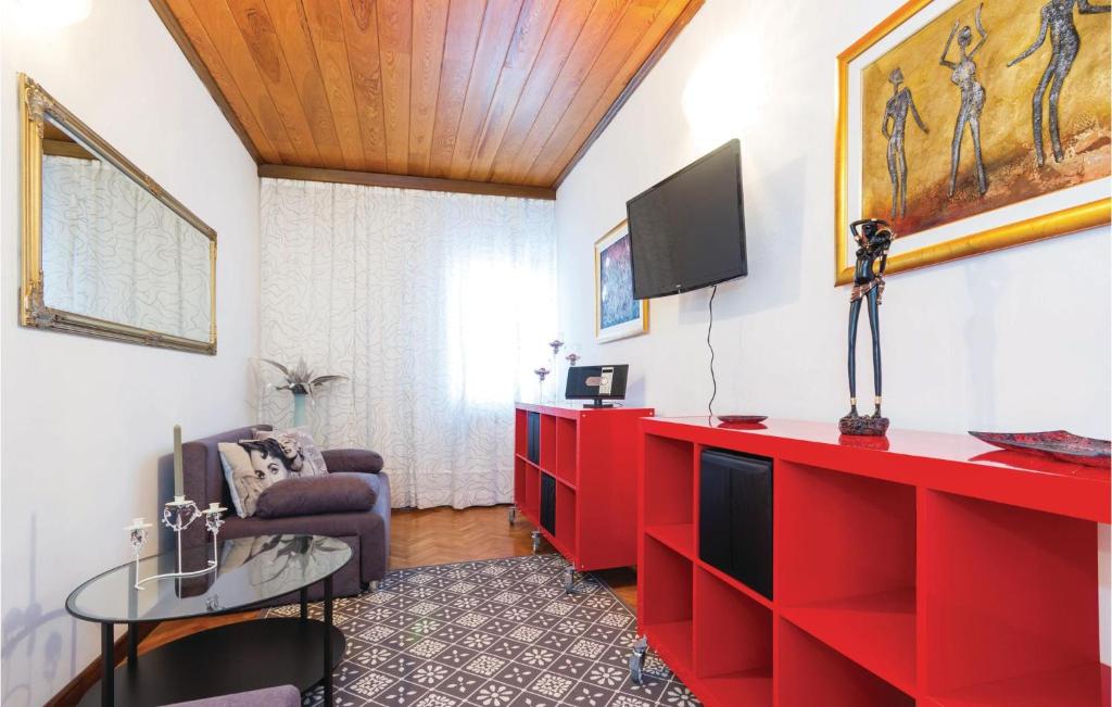 a living room with red cabinets and a tv at Amazing Apartment In Rijeka With House A Panoramic View in Rijeka