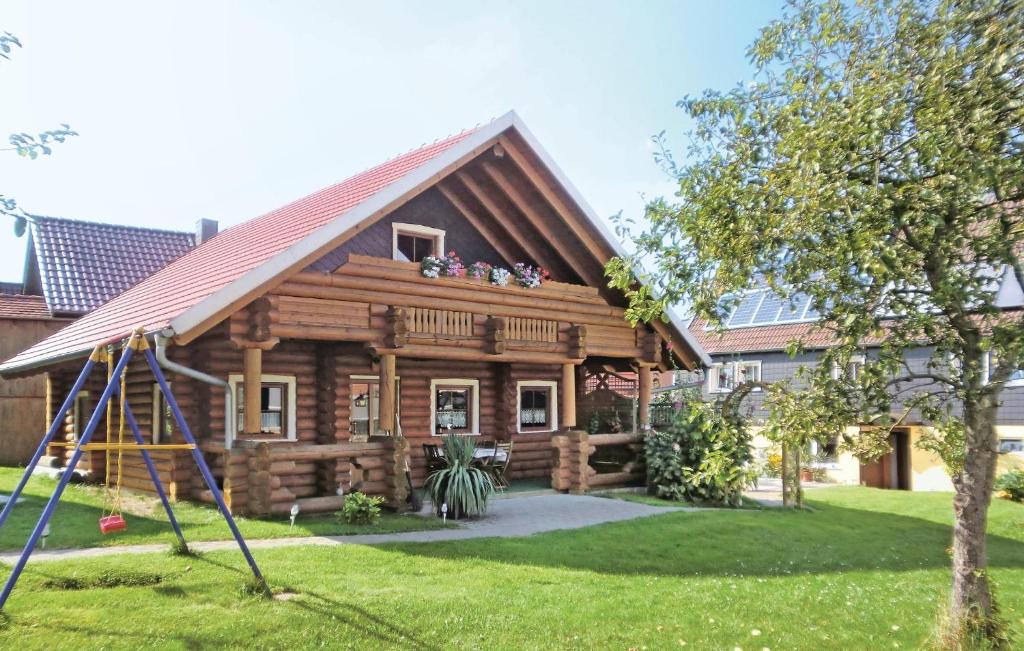 a log cabin with people sitting on the roof at Amazing Home In Harzgerode-dankerode With Wifi in Dankerode