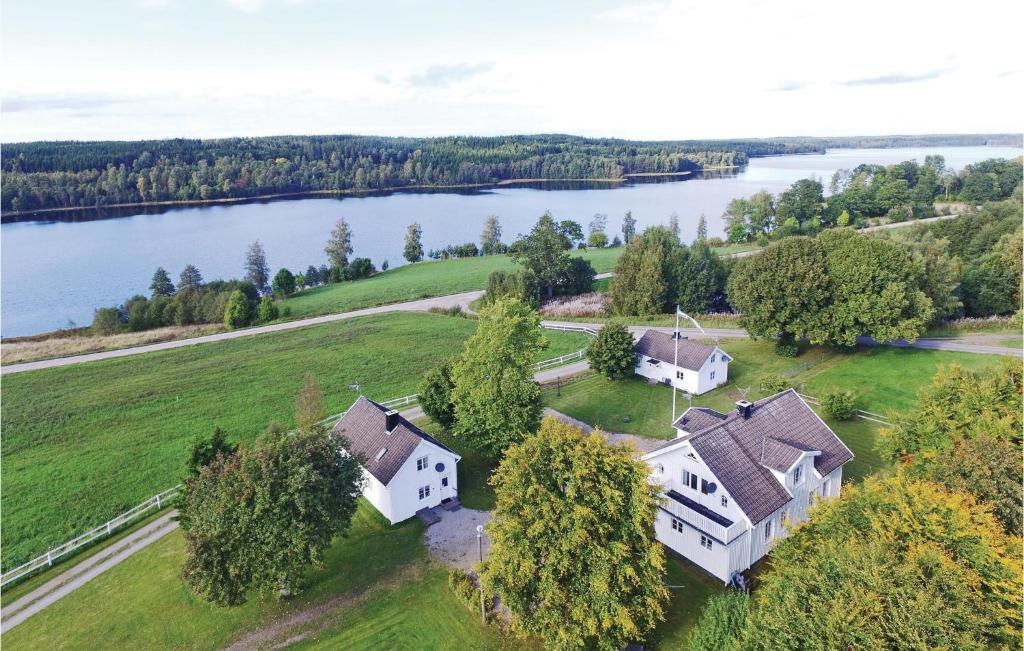 an aerial view of a house with a lake at Beautiful Home In Dalum With Kitchen in Tomten