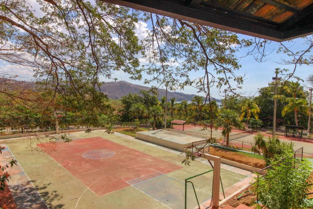 an image of a basketball court with mountains in the background at Villa Sol in Playa Hermosa