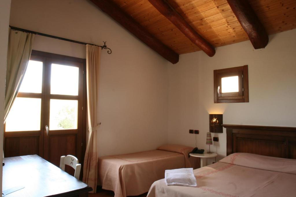 Postel nebo postele na pokoji v ubytování Hotel S'Abba e Sa Murta