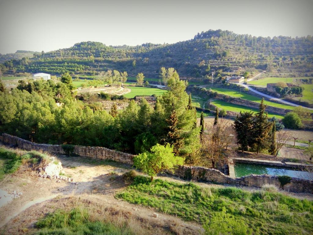 a view of a valley with a river and trees at Cal Baster in Vallbona de les Monges