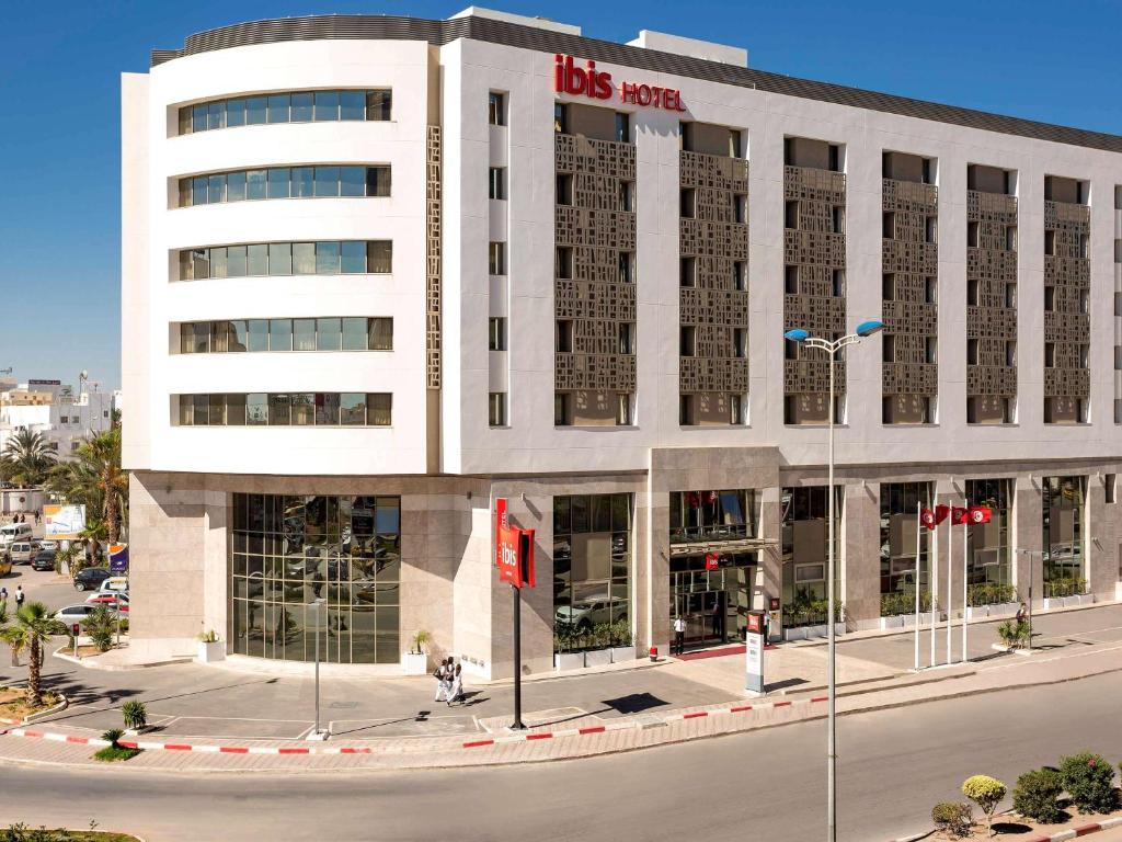 a large white building with a lot of windows at Ibis Sfax in Sfax
