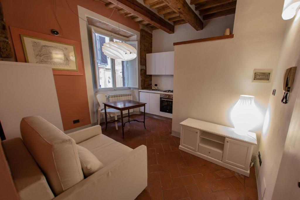 a living room with a couch and a table at Toselli new suite in Pisa