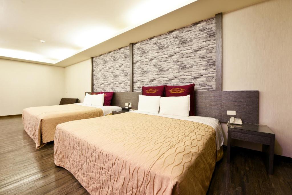 Postel nebo postele na pokoji v ubytování Carnival Motel