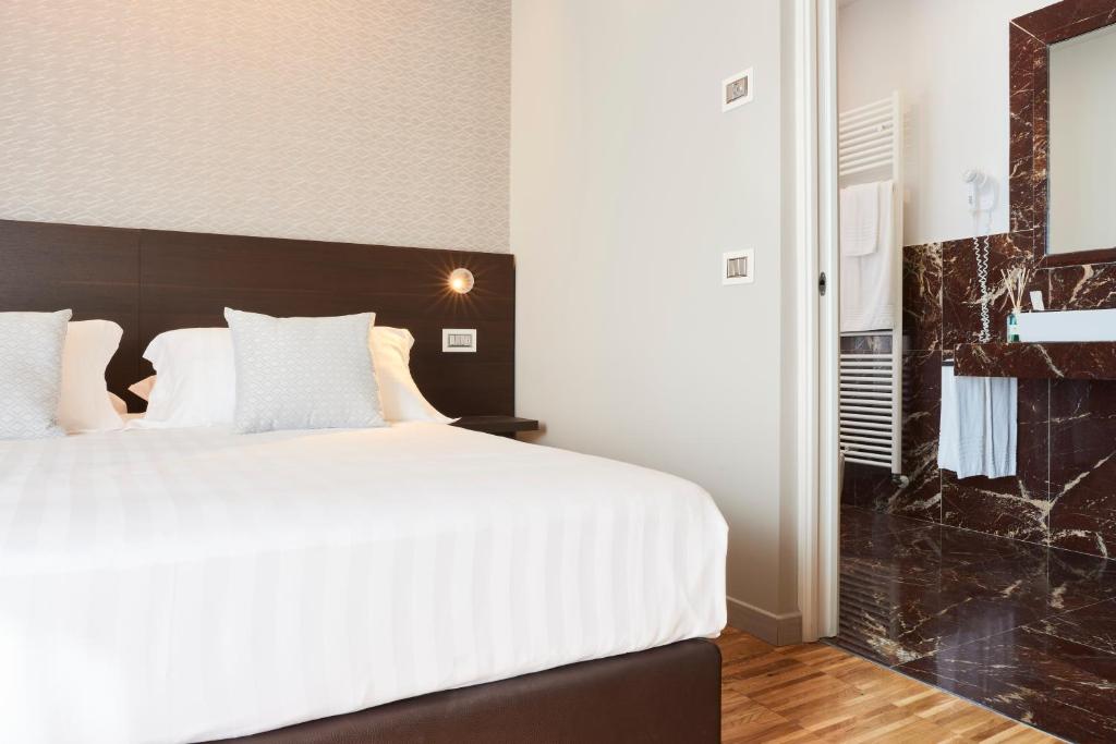 Posteľ alebo postele v izbe v ubytovaní Hotel Michelangelo
