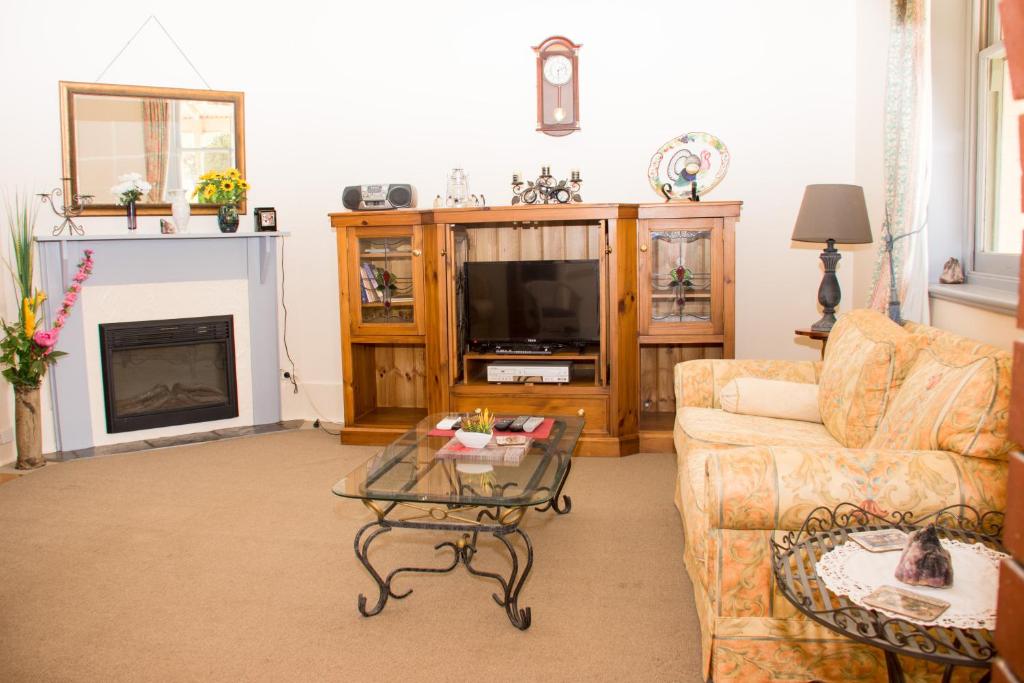 a living room with a couch and a fireplace at Kimba Travellers' Haven in Kimba