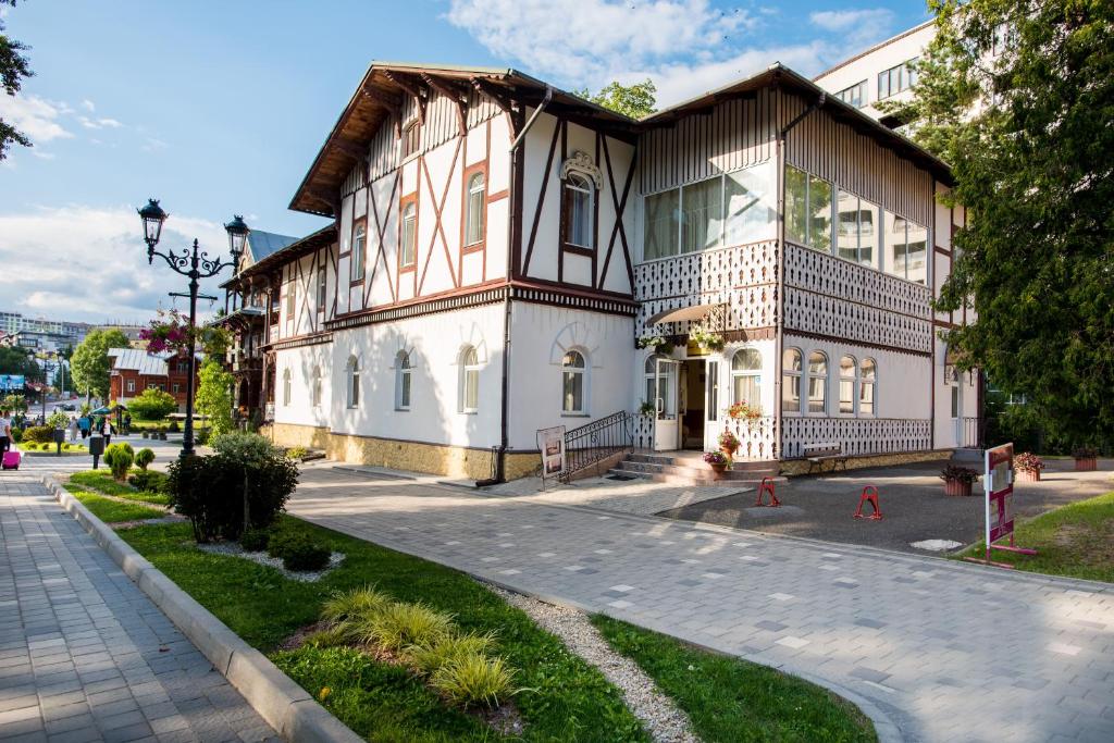 a large building on the side of a street at Villa Viktoriya Hotel in Truskavets