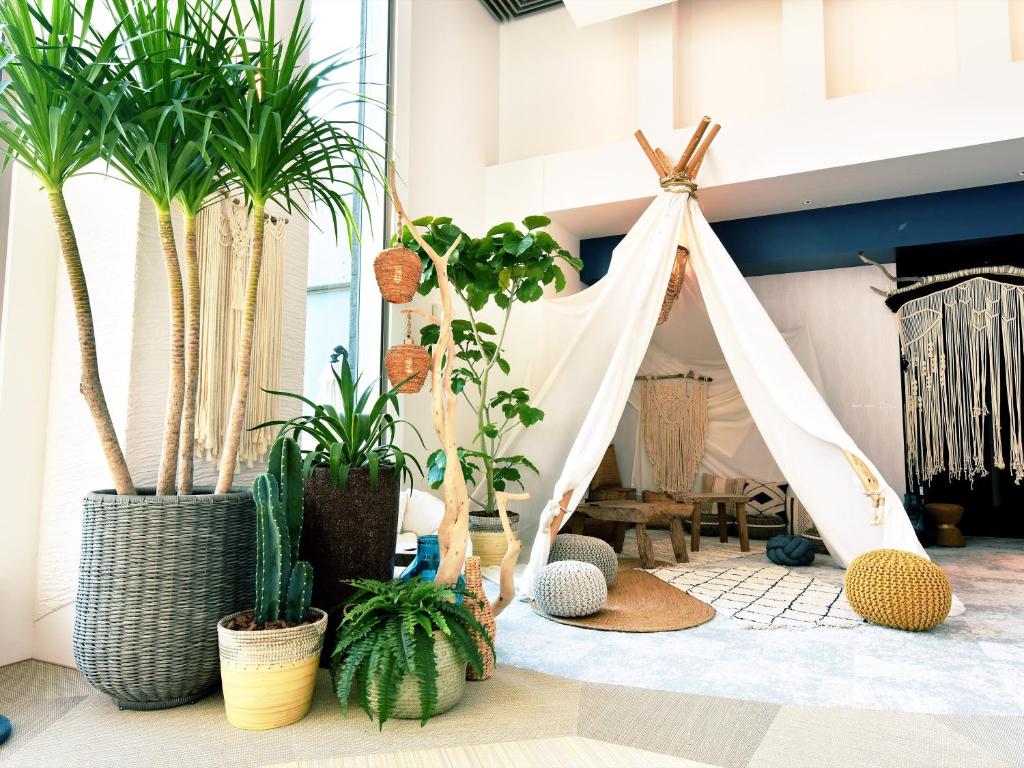 a room with potted plants and a tent at Hayama Umino Hotel in Hayama