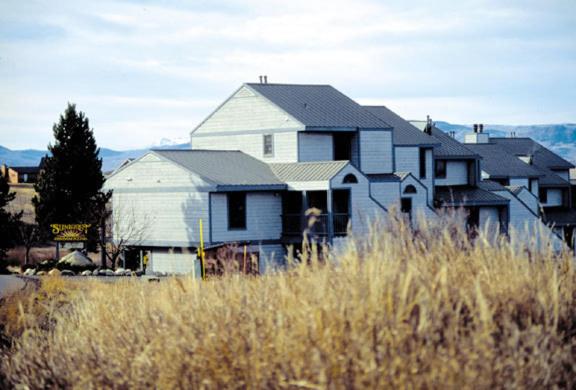 une grande maison dans un champ d'herbe haute dans l'établissement Sunburst Condominiums, a VRI resort, à Steamboat Springs