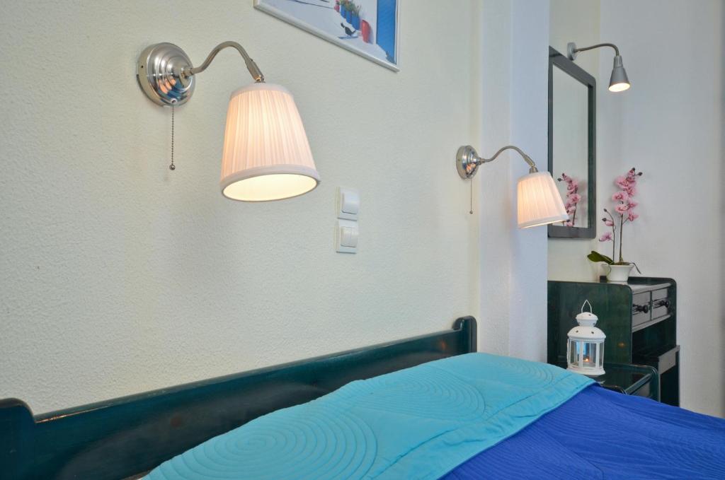 Postel nebo postele na pokoji v ubytování Dilino Hotel Studios