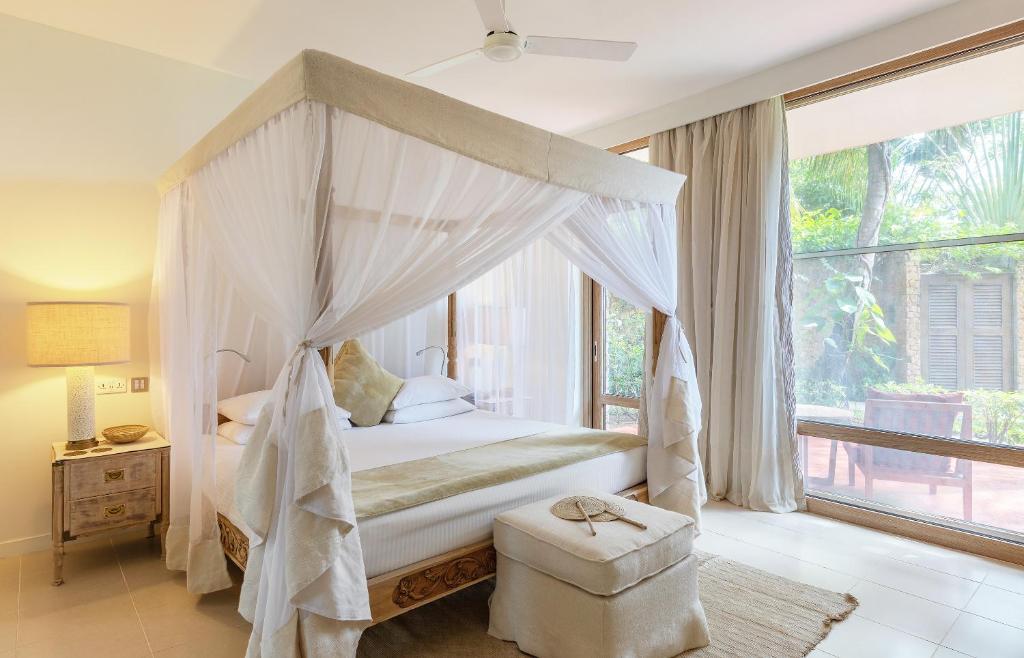 Postel nebo postele na pokoji v ubytování Melia Zanzibar