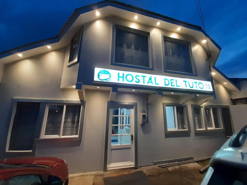 a hostel deluxe building with a sign on it at Hostal Del Tuto in Punta Arenas