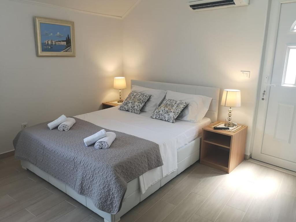 a bedroom with a bed with two pillows on it at Apartment Ivka in Dubrovnik