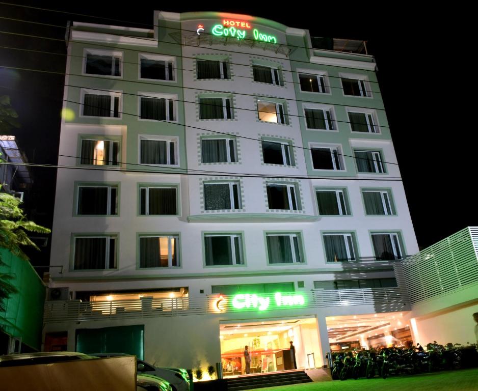 a white building with a sign on it at night at Hotel City Inn in Varanasi
