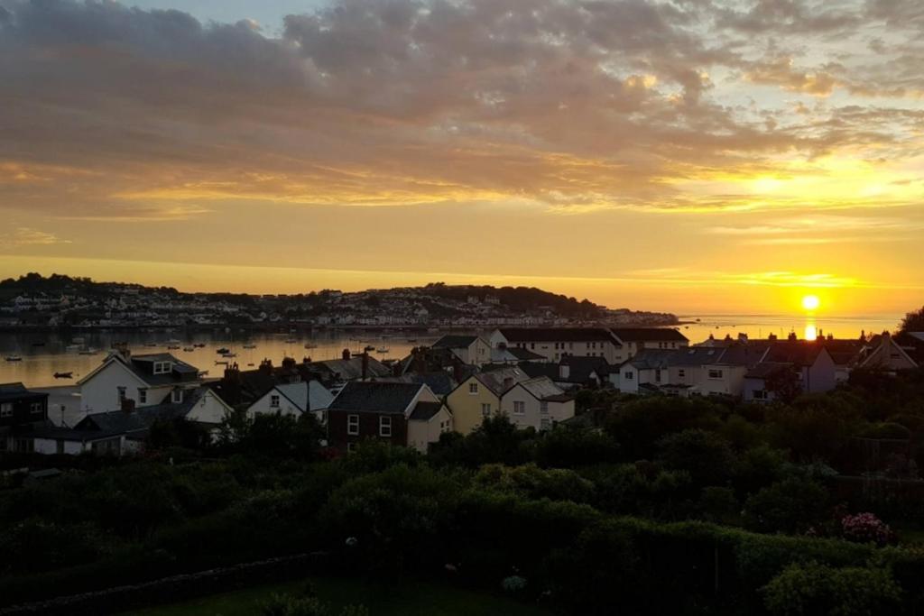 a view of a city with the sunset in the background at Moorings View in Instow