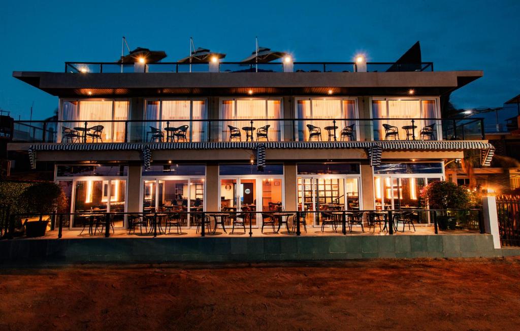 a building with tables and chairs in front of it at Royale Exotica, Goa in Calangute