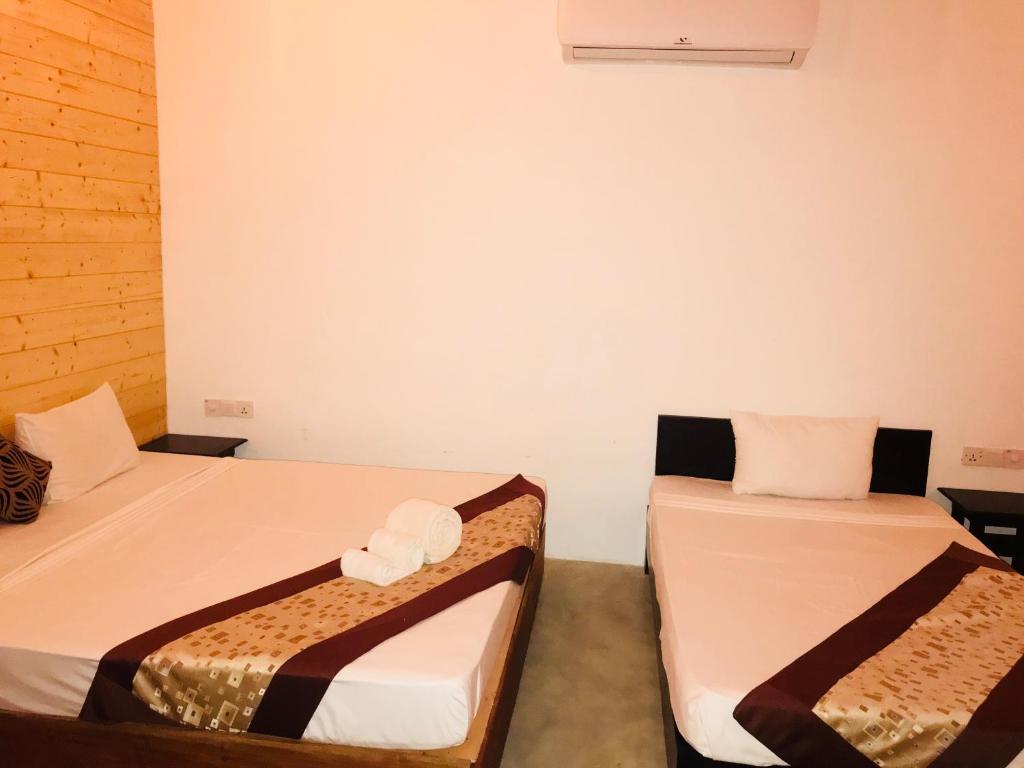 Postel nebo postele na pokoji v ubytování Trinco Relax Hut