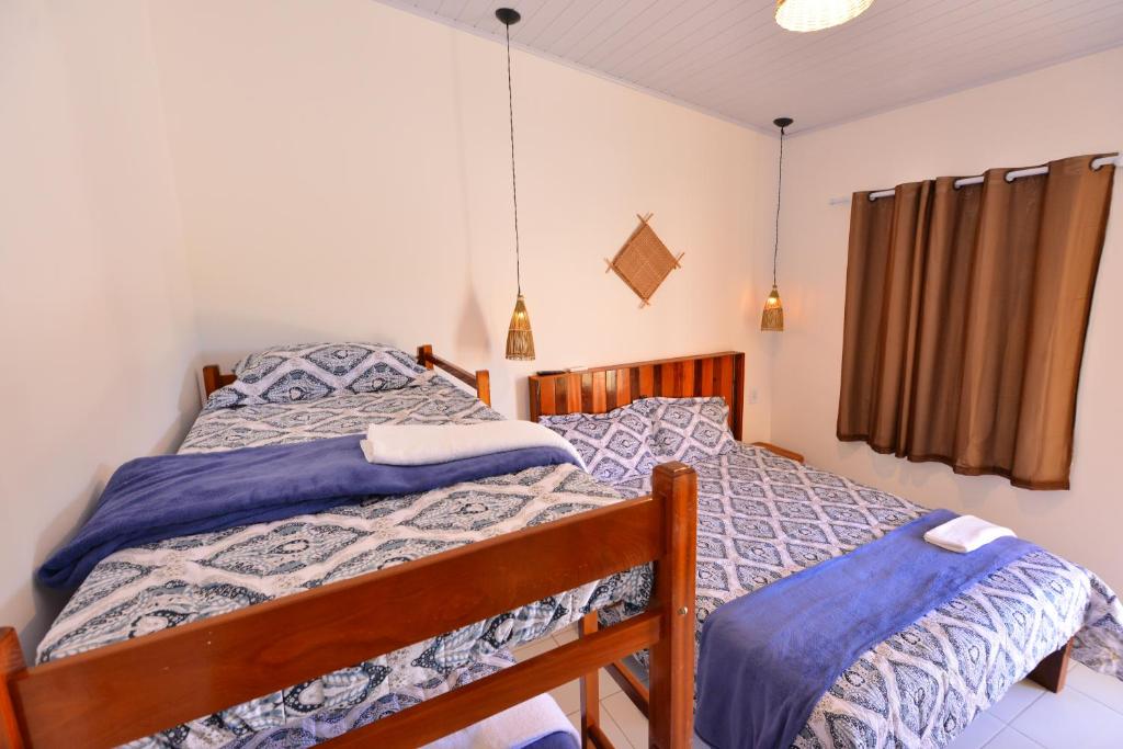 Postel nebo postele na pokoji v ubytování Vila Capininga Ecopousada