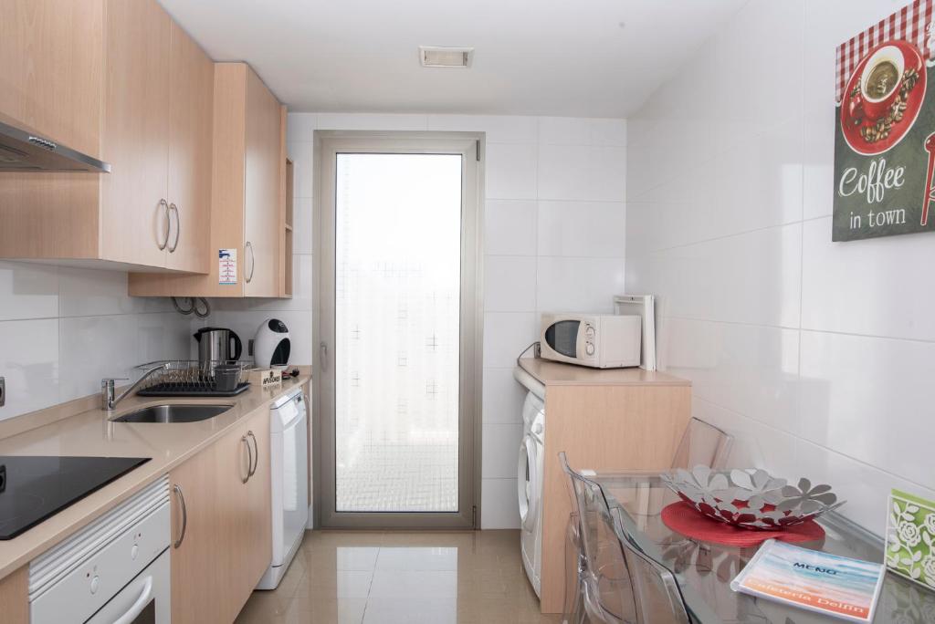 Kuchyň nebo kuchyňský kout v ubytování Apartaments Delfin