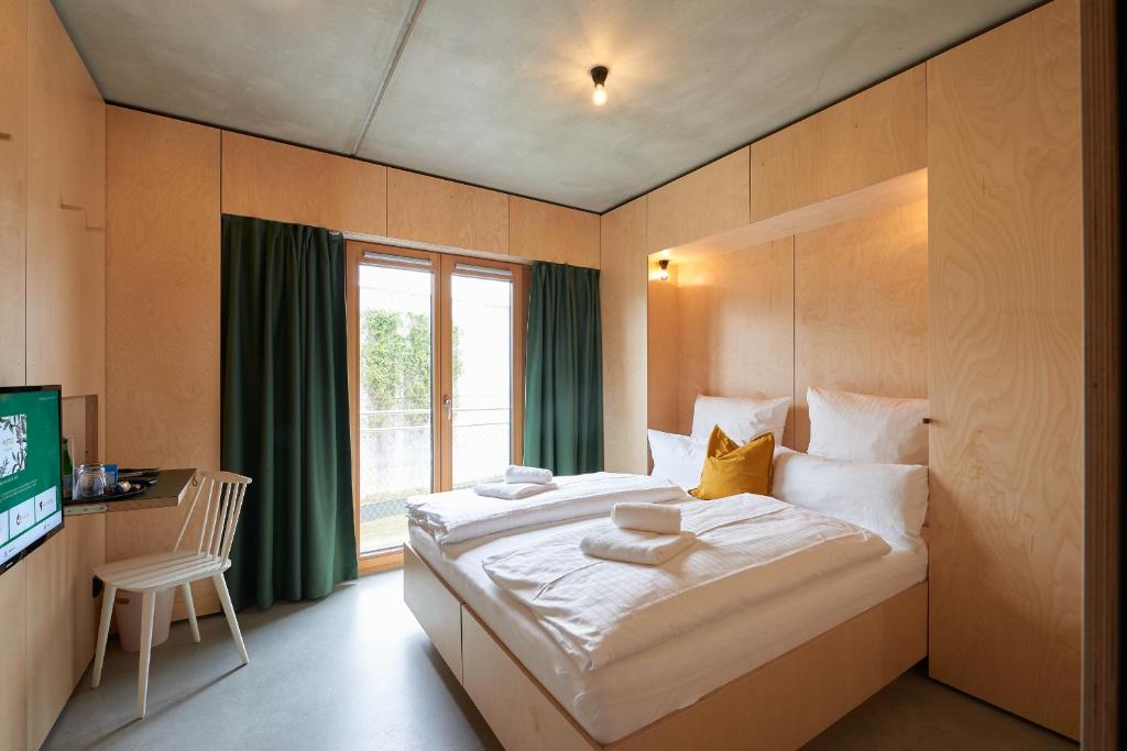 een slaapkamer met een groot bed en een raam bij Kitz Boutique Hotel & Restaurant in Metzingen