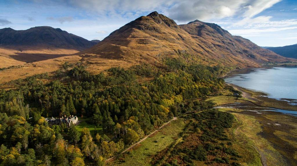 an aerial view of a mountain with trees and water at Torridon Estate B&B Rooms and Self catering Holiday Cottages in Torridon