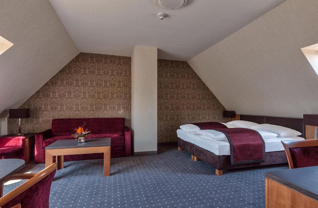 Postel nebo postele na pokoji v ubytování Club Hotel Cortina