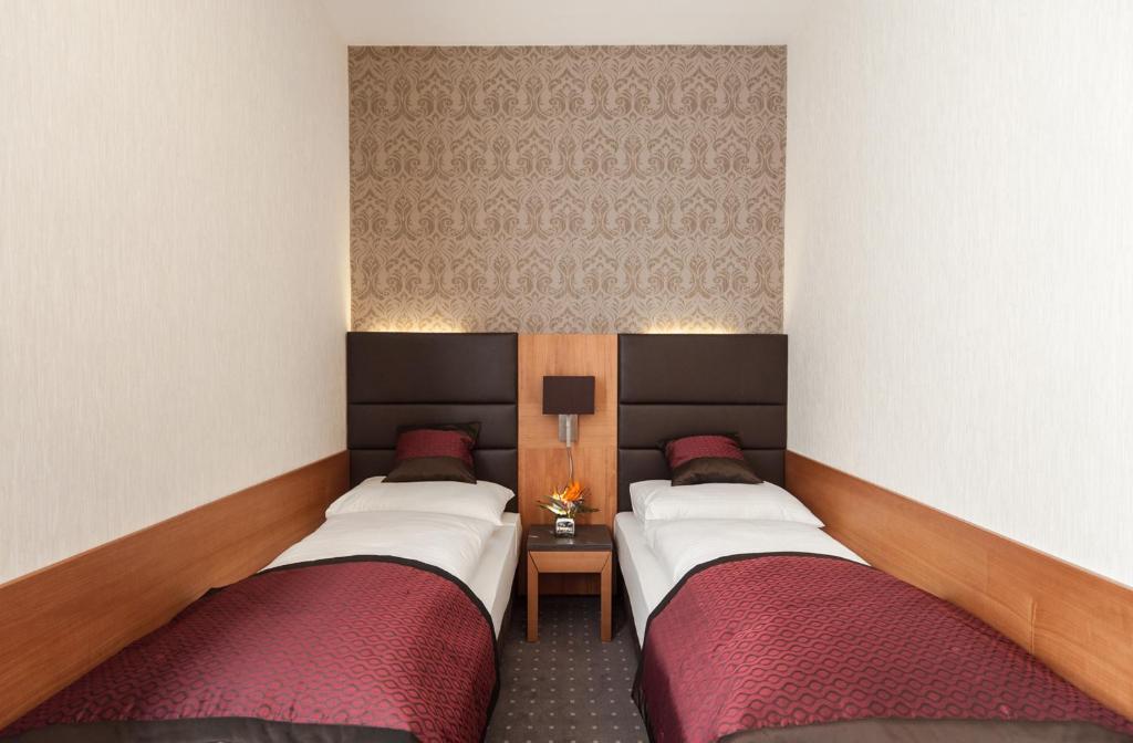 Postel nebo postele na pokoji v ubytování Club Hotel Cortina