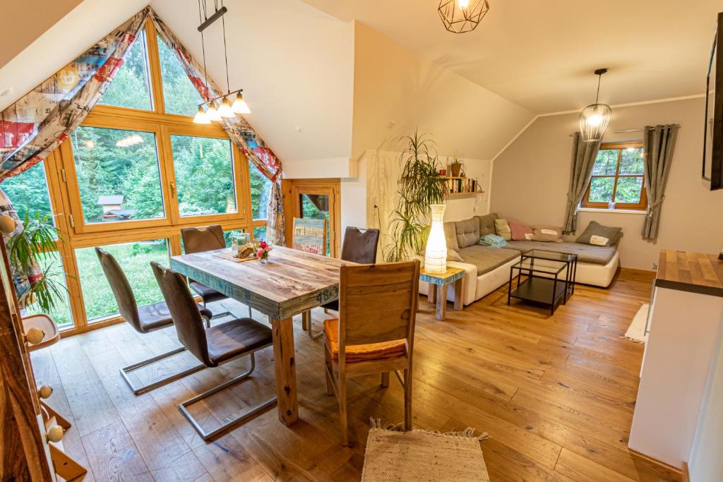 a dining room and living room with a table and chairs at Ferienhaus Göstling in Göstling an der Ybbs