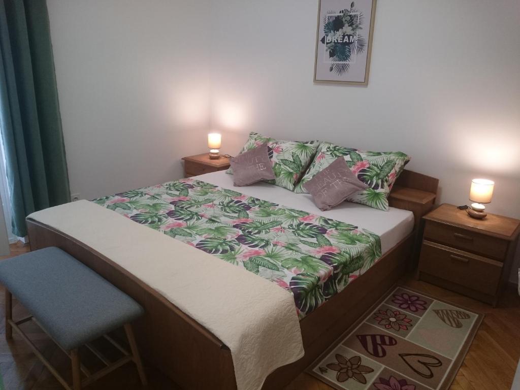 - une chambre avec un lit, une chaise et deux lampes dans l'établissement Apartman Sanja, à Rovinj
