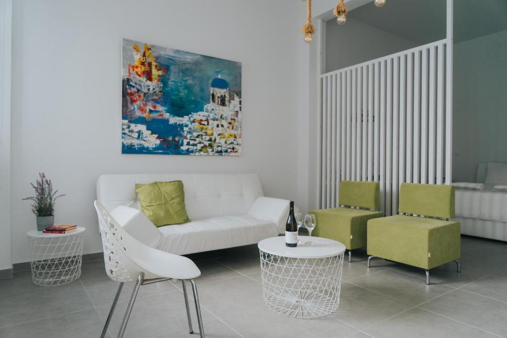 a living room with a couch and two chairs and a table at Prima Gardens City Studios in Larnaca