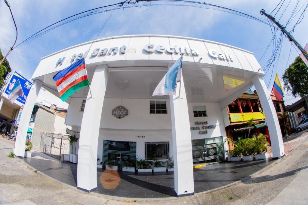 a building with flags in front of it at Hotel Santa Cecilia Cali in Cali