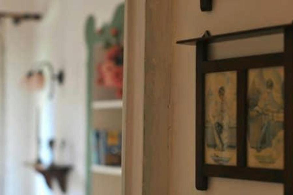 a picture hanging on a wall in a room at B&B del Giglio in Cefalù