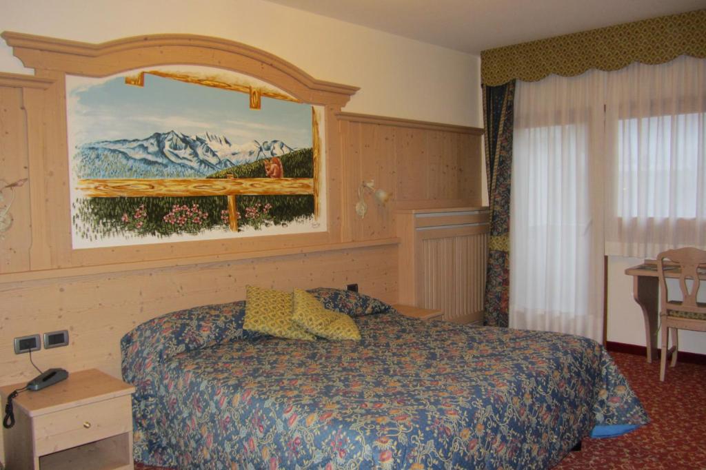 Postel nebo postele na pokoji v ubytování Hotel Ortles Dolomiti Walking & Spa