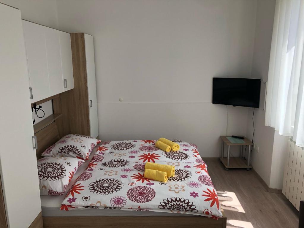 a bedroom with a bed and a television in it at Apartments & Rooms Nardin in Izola