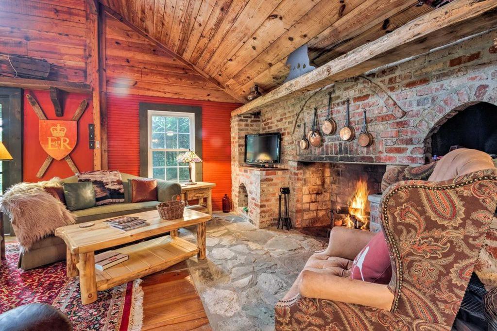 a living room with a stone fireplace in a cabin at Ginny's Cabin in Spruce Pine