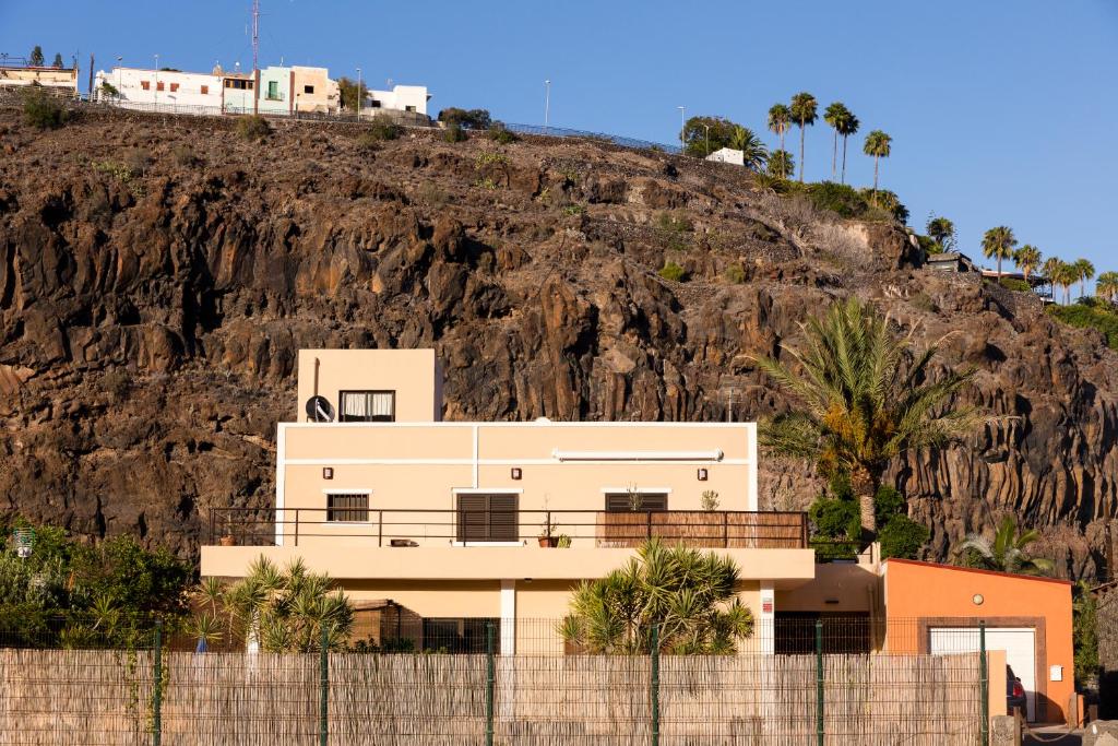 a house on the side of a hill at Los Olivos in Playa de Santiago